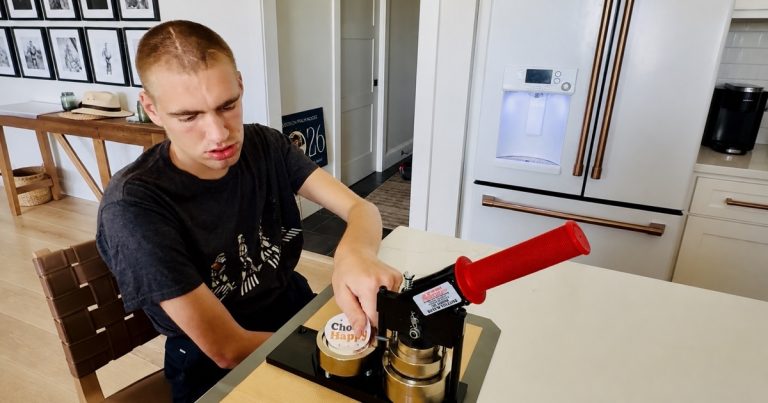 Carter using a button press to make a Choose Happy product