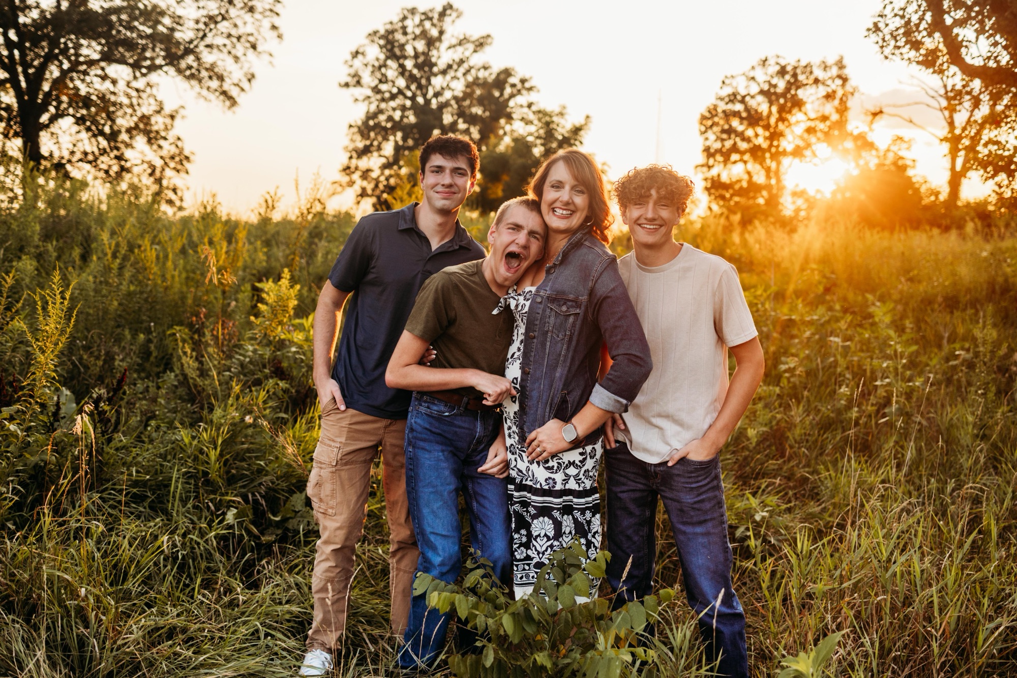 img_6803 Gina and her three sons together outdoors at sunset.